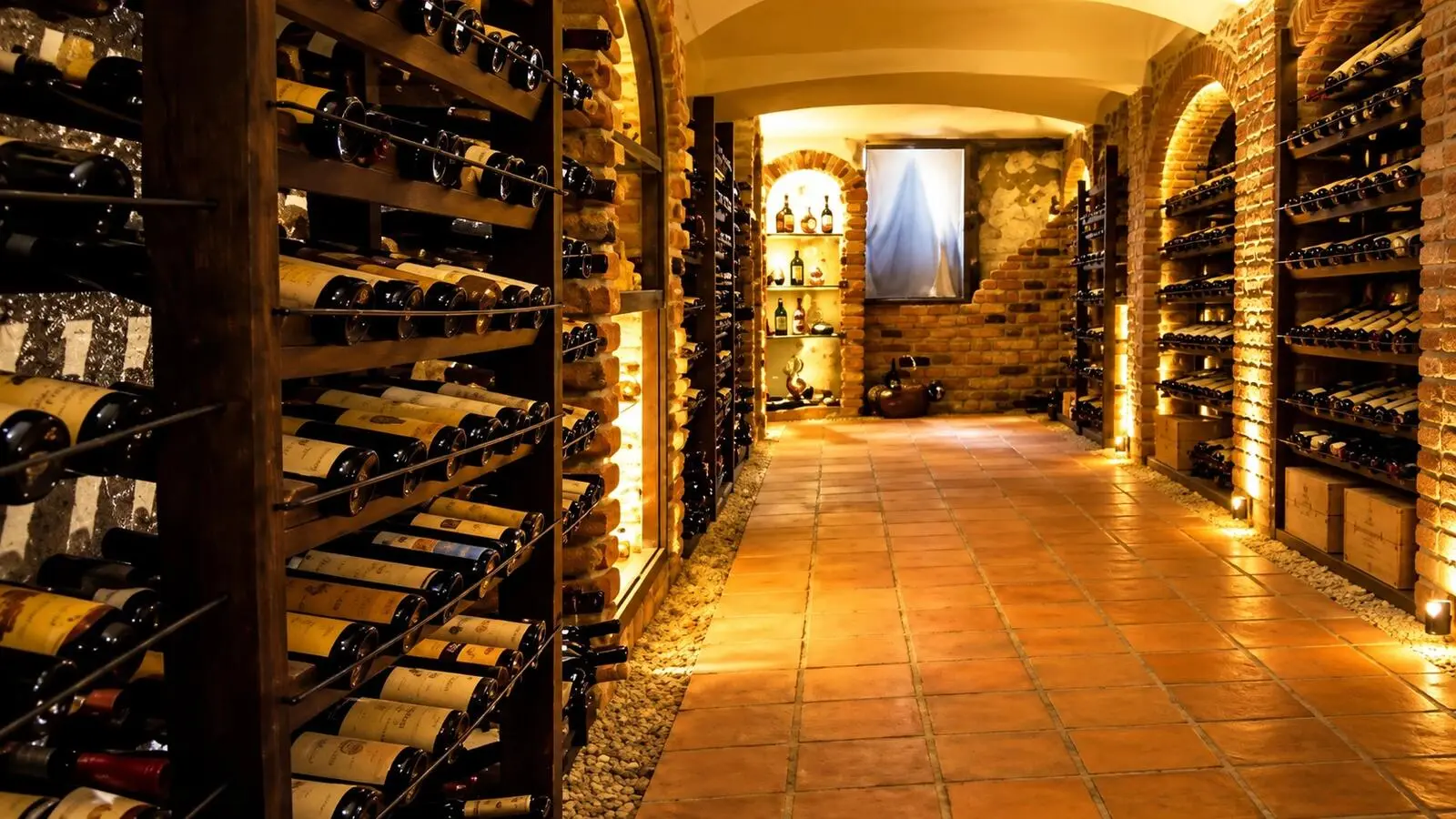A vaulted brick wine cellar lined with bottle racks